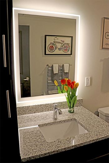Granite bathroom vanities & back lit mirrors